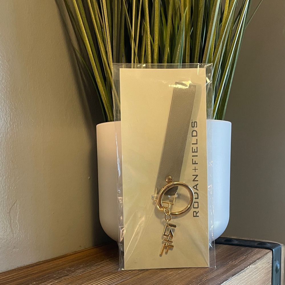 Rodan + Fields Stylish Gray Keychain with Gold Ring